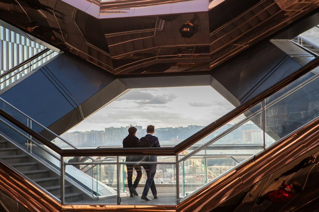 Colleagues talking in an open-plan office